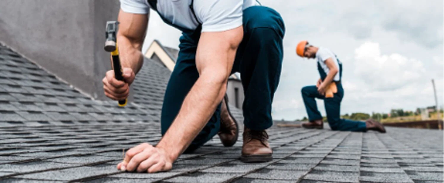 Roofing contractor inspecting roof on a clear day on the Central Coast NSW